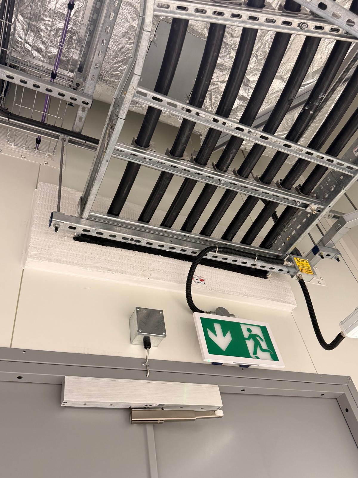 Fire stopping work on cable trays in a live commercial building, Manchester