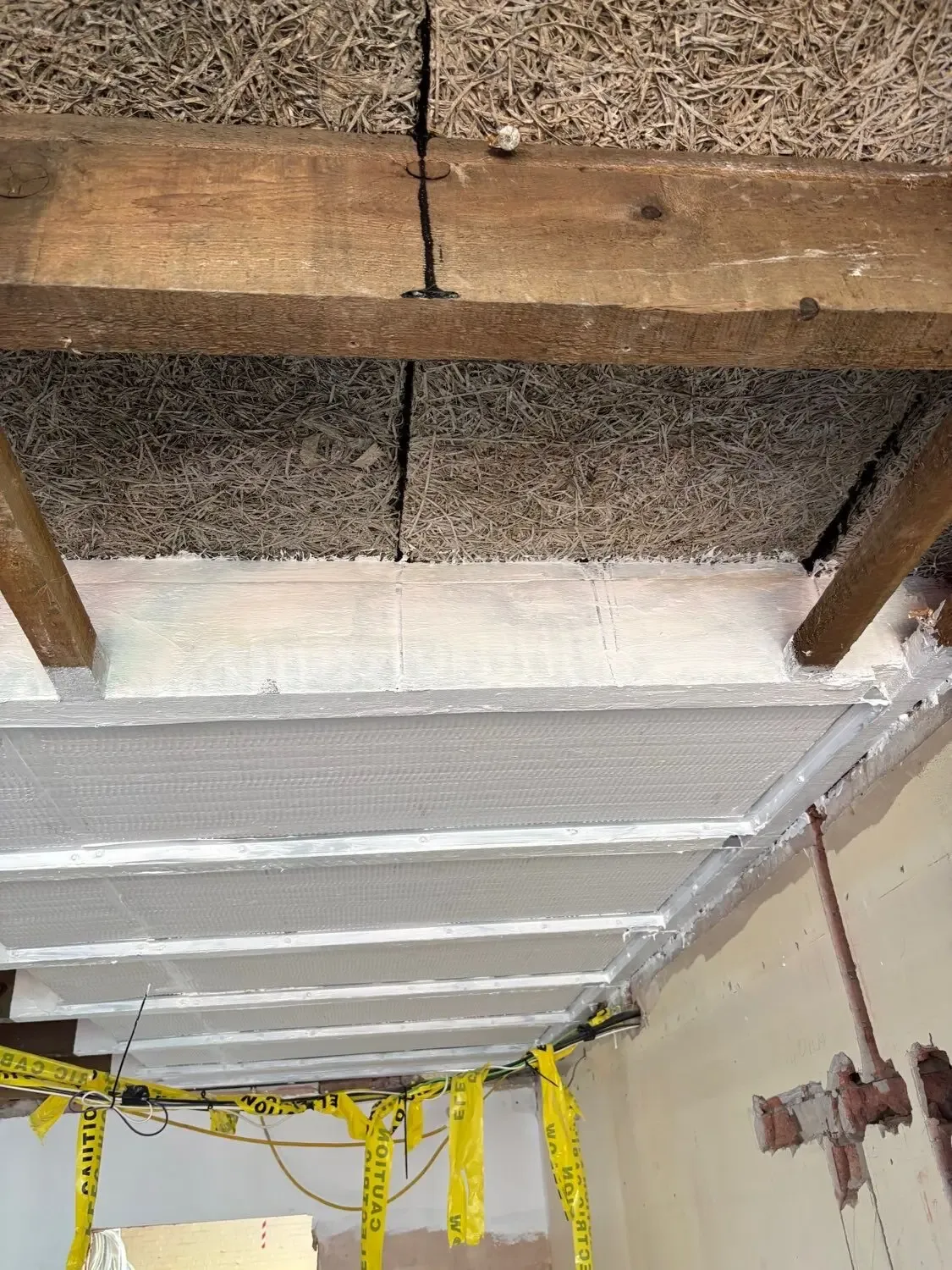 Intumescent paint structural steel — Manchester, Chorlton-cum-Hardy M21: white-coated steel beams beneath an existing soffit.