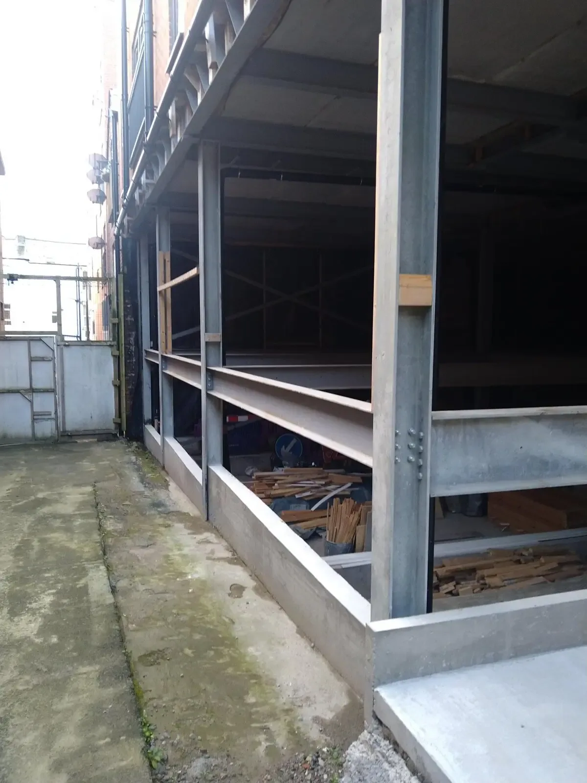 Intumescent paint structural steel — Manchester, Didsbury M20: dark-coated structural steel frame at an external wall.